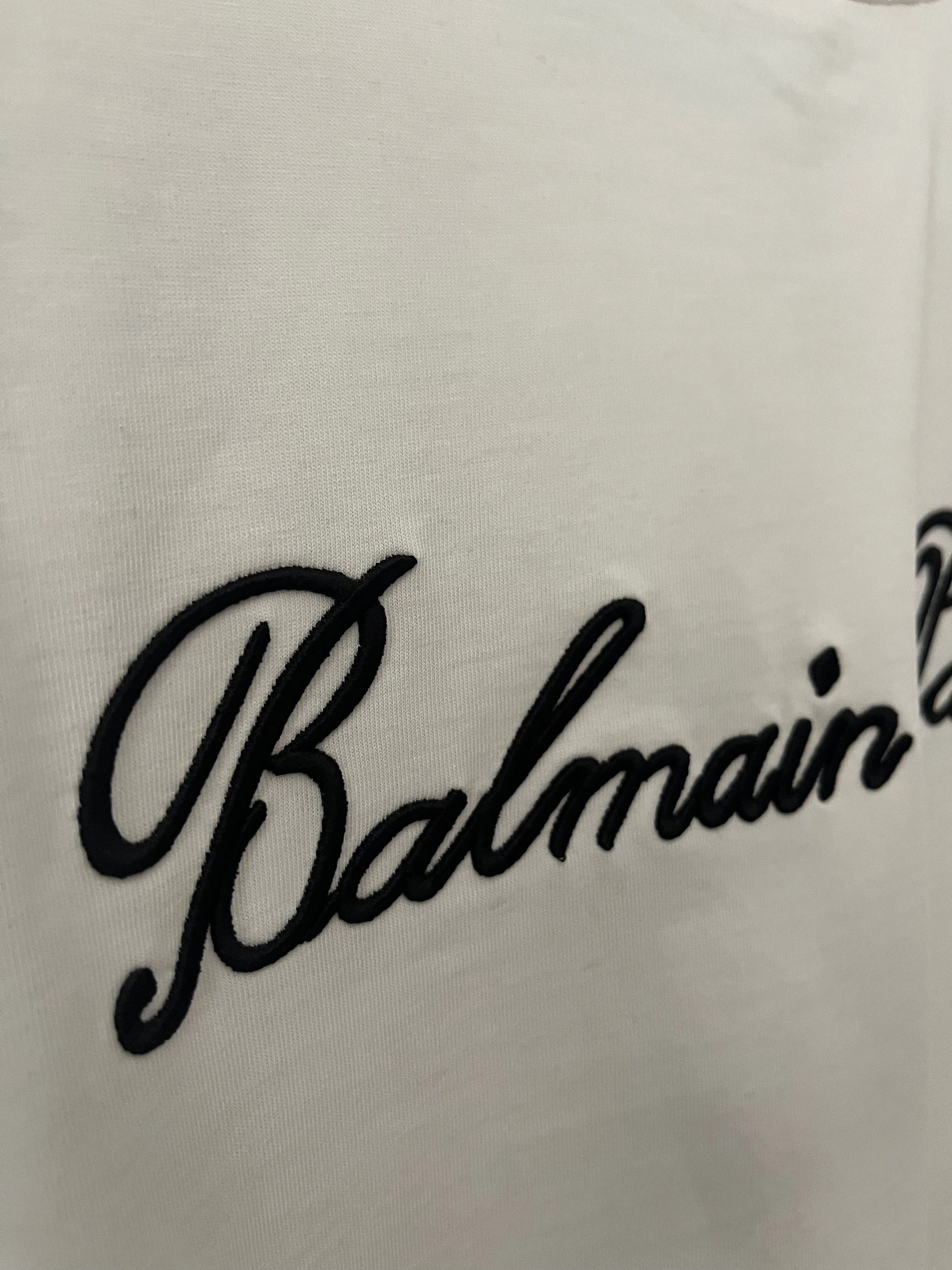 Balmain "Signature Logo Embroidered" T-Shirt styled in White for Spring/Summer 2024